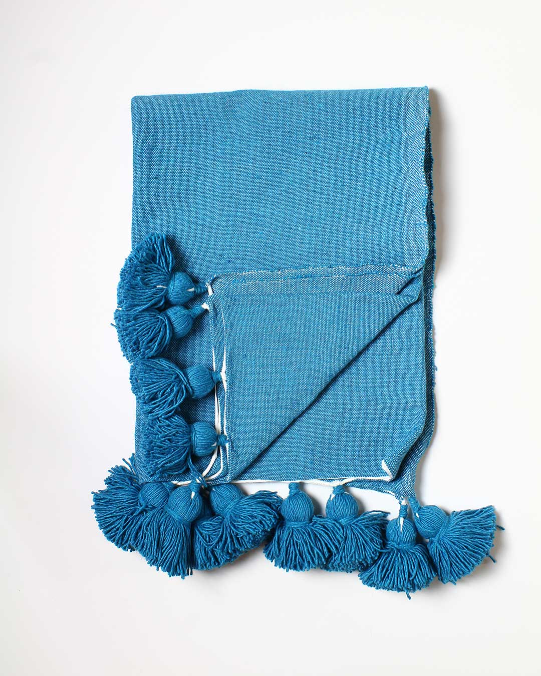 turquoise throw pompom blanket